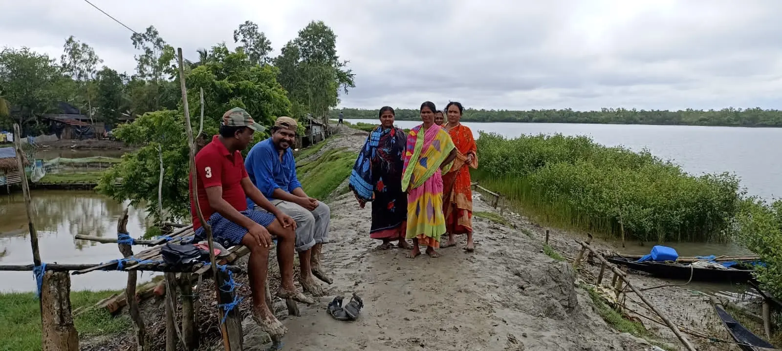 Community members beside a mangrove-lined waterway in the Sundarbans